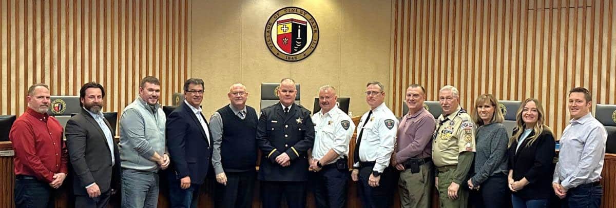 Mayor Michael Glotz stands third from left alongside many other members of the Tinley Park Village Board and village staff.